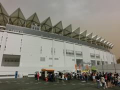 Machida Municipal Stadium exterior view with empty stands and clear sky