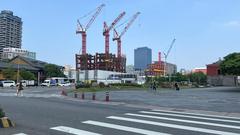 Northeast view from Zhonghua Road and Zhongxiao West Road intersection in Taipei showing National Taiwan Museum Railway Department Park, Taipei Twins construction site, Taoyuan Metro Taipei Station, and Taipei North Gate