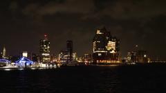 Elbphilharmonie concert hall illuminated at night in Hamburg harbor