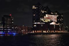 Elbphilharmonie concert hall illuminated at night in Hamburg harbor