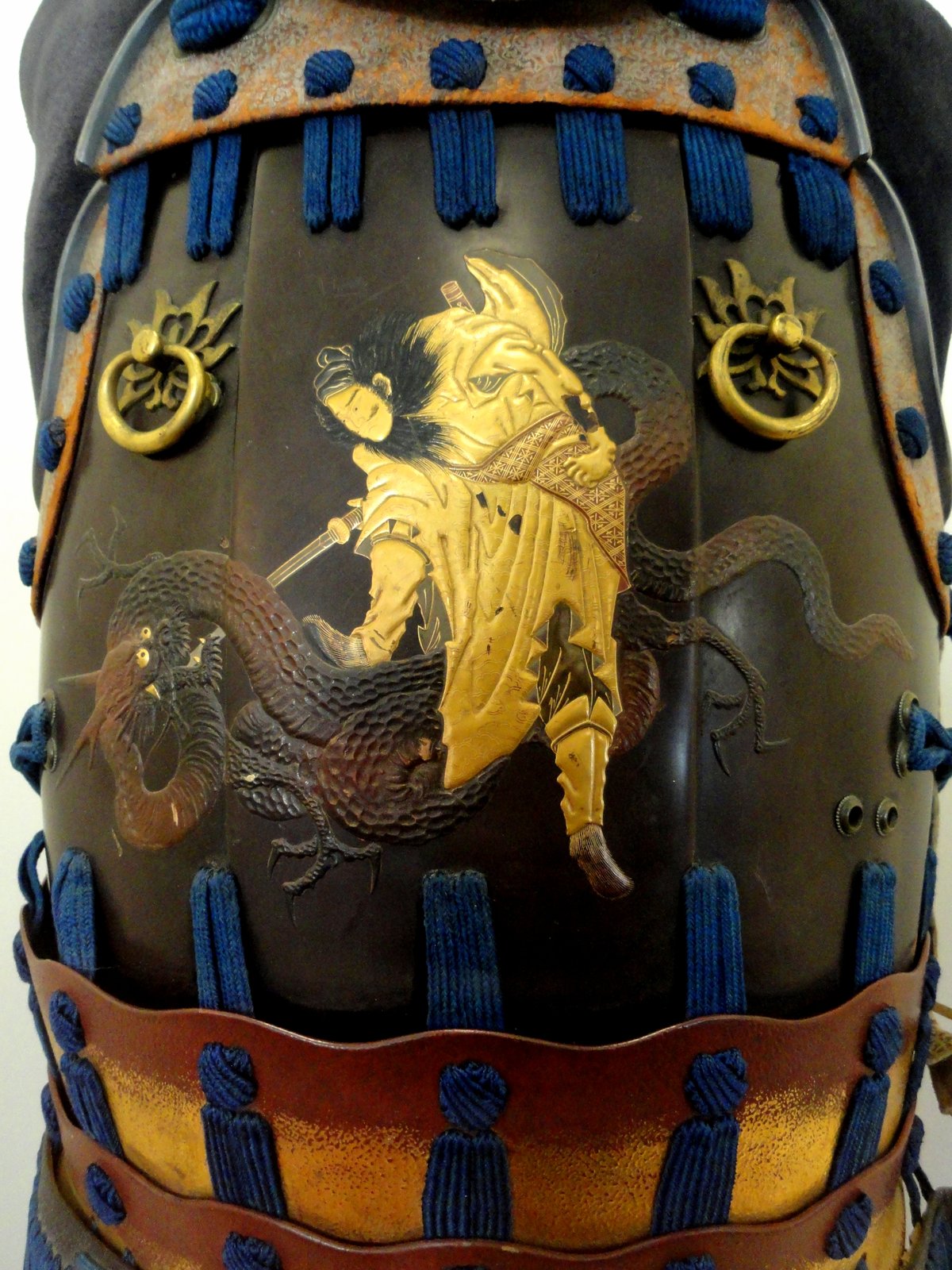 Detail of Samurai armor depicting a samurai slaying a dragon at the San Diego Museum of Man