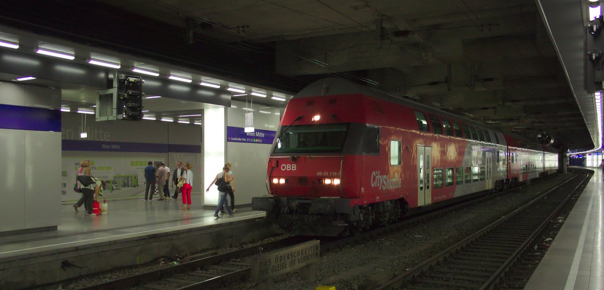 Double-decker train with control car 86-33 119-7 stopped at platform 3 of Vienna Mitte station, view from platform 2
