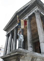Flag of the 2nd Foreign Infantry Regiment displayed on the walls of the Maison Carrée in Nîmes, France