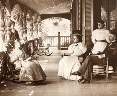 Francese Litchfield Turnbull seated in rocking chair with her family at La Paix estate near Towson MD