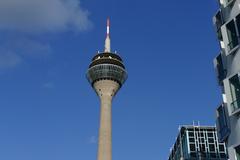 Rheinturm tower in Düsseldorf against a blue sky