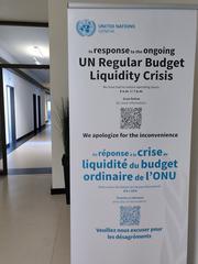 UN Regular Budget Liquidity Crisis poster displayed in Geneva with a visual representation of financial distress