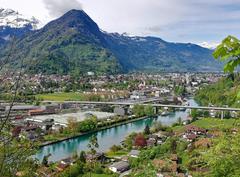 Panoramic view of Goldswil Viaduct with Goldswil village and Aare River in the foreground and Interlaken with surrounding mountains in the background