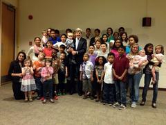 U.S. Secretary of State John Kerry posing with children at U.S. Embassy Riyadh