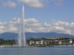 Jet D'Eau water fountain in Geneva with blue sky and cityscape