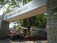 Manila North Cemetery Blumentritt Extension entrance with Manila and Quezon City Highway boundary and Quezon City Welcome Road sign