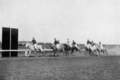 Athlete crossing finish line with a well bunched group