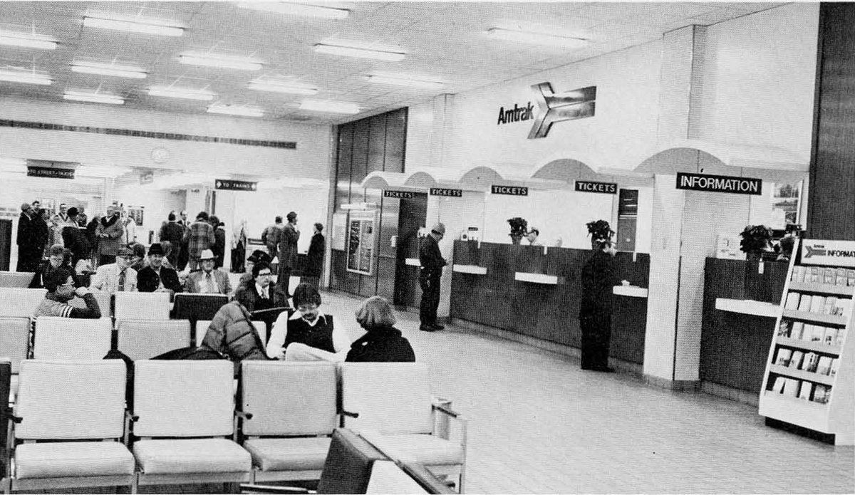 Interior of Milwaukee Amtrak station in 1976 showing platform and trains