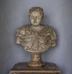 Marble bust of a child wearing a draped cloak and vine-leaf wreath in Munich Residenz