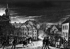 View of the intersection of Długa and Miodowa streets in Warsaw featuring historical xylographs of the November Uprising