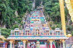Entrance to Batu Caves with large golden statue and steep staircase