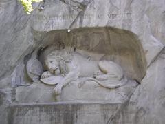 Lion Monument in Lucerne carved into a rock face with a sorrowful lion and soldiers