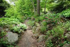 Entrance to Morris Arboretum with brick walls, stone pillars, and colorful gardens in Chestnut Hill Philadelphia