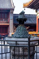 Fountain at Yonghe Temple in Beijing surrounded by traditional architecture and visitors