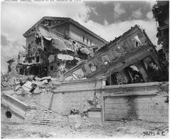 Demolished Legislature Building in Manila after bombing during WWII with Filipino citizens observing the ruins