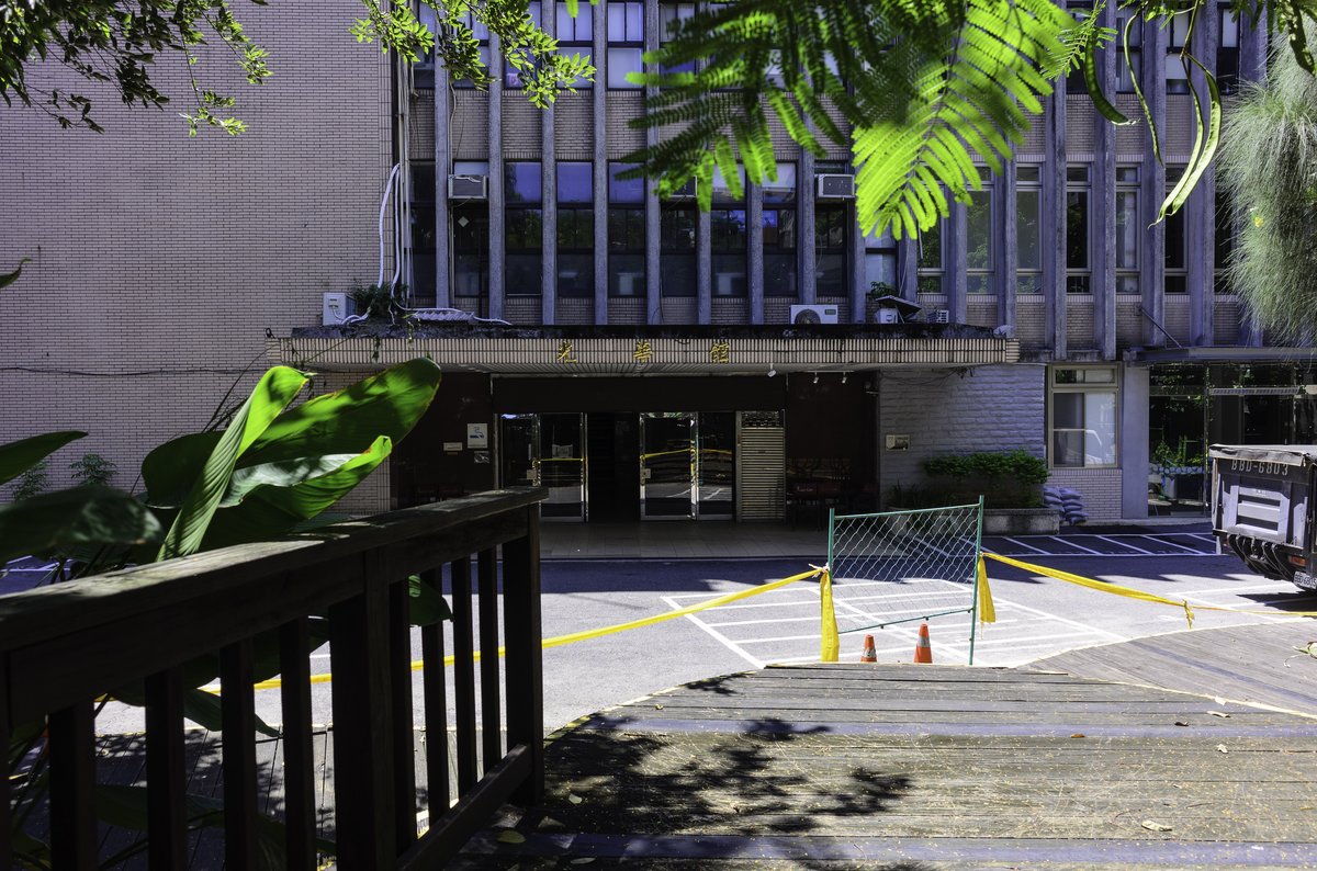 Main entrance of Guang Hua Building and motorcycle parking grids at National Taipei University of Technology
