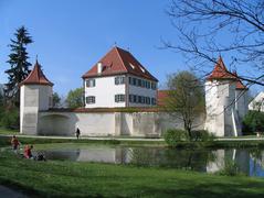 Castle Blutenburg in Munich, Germany surrounded by trees and blue sky