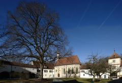 Winter view of the courtyard of Blutenburg Castle in Obermenzing, Munich with a summer lime tree
