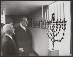 Dr. W. Drees and E.A. Rodrigues Pereira near a menora at the reopening of the Jewish Historical Museum in Amsterdam
