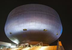 Exterior of BMW Museum at dusk with modern architecture and illuminated windows
