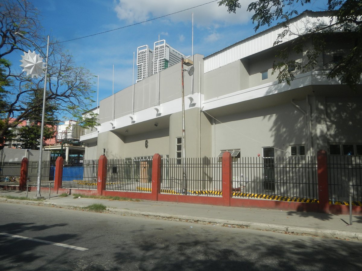 Intersection of Adriatico and Pablo Ocampo Streets in Malate, Manila with façades of Rizal Memorial Coliseum, Rizal Memorial Sports Complex, Philippine Sports Commission, and Rizal Memorial Stadium in 2019 under cloudy weather