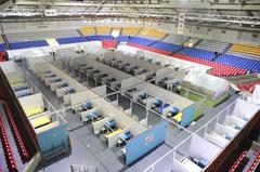 Ninoy Aquino Stadium converted into a COVID-19 quarantine center with rows of bed cubicles and medical staff