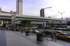 Skyscraper Shin Kong Life Tower with nearby roads and a large bus in front