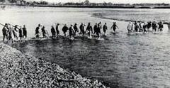 Squadron under Captain Pajota crossing Pampanga River en route to Cabu Bridge ambush position, January 30, 1945