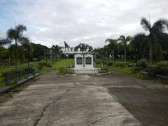 Park at Camp Pangatian Memorial Shrine with a pathway, trees, and a monument