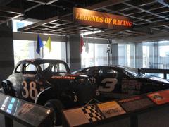 Interior of North Carolina Museum of History showcasing vintage race cars