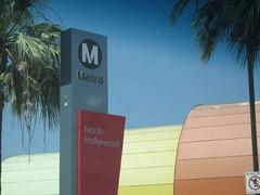 North Hollywood Metro Station entrance with modern architectural design and clear glass walls under a bright blue sky