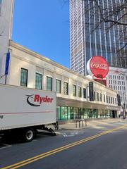 Olympia Building in Atlanta Georgia with multiple business signs on a bright sunny day