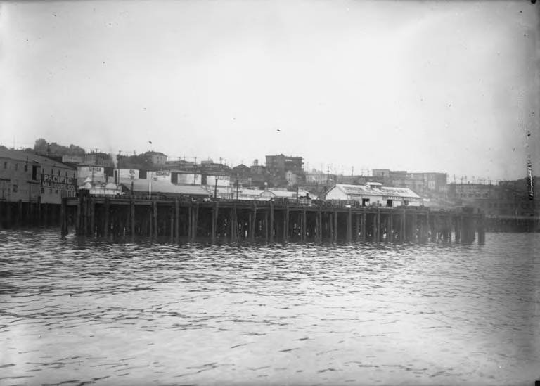 Historic waterfront businesses including Union Oil Company and Pacific Mildcure Company in Seattle circa 1917-1920
