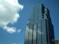 1KC Place building seen during daytime with blue sky and clouds