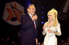 Secretary of Defense Donald H. Rumsfeld and country music legend Dolly Parton on stage at the Grand Ole Opry in Nashville during a live broadcast