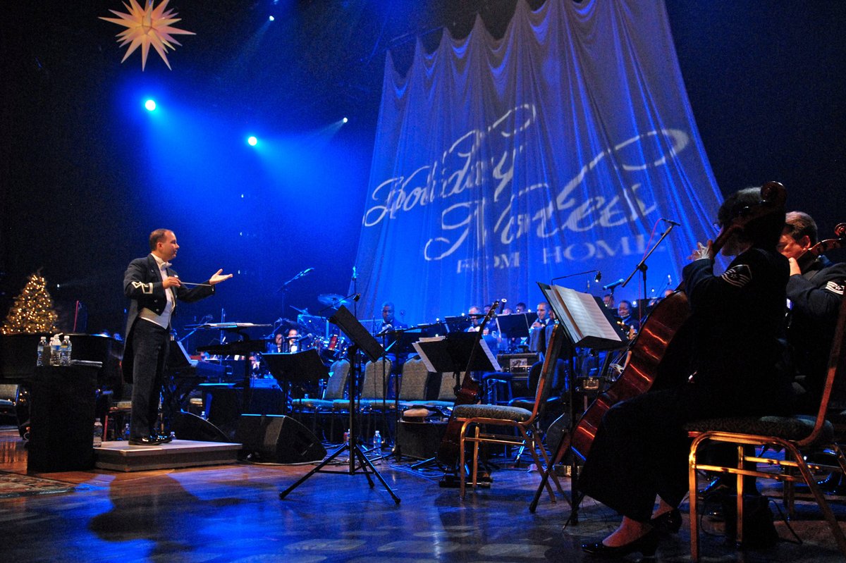 Air Force Maj. Don Schofield conducting a large orchestra at the Grand Ole Opry House in 2008