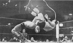 Tiger Mask performing a German suplex on Black Tiger in a wrestling match