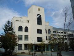 Tanioka Memorial Hall at Osaka University of Commerce under clear blue sky
