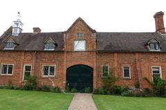 Outbuildings at Packwood House in Warwickshire, England with traditional architecture and greenery
