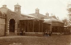 Artis Zoo monkey house exterior with visitors, families, and children in Amsterdam, 1909