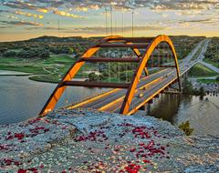Pennybacker Bridge with rose petals floating on the water in Austin Texas