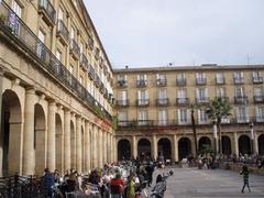 Plaza Barria in Bilbao with people walking and historical buildings
