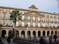 Plaza Barria square in Bilbao with historic buildings and a mountainous backdrop