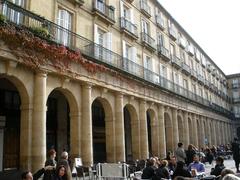 Plaza Barria in Bilbao with historic buildings and people walking