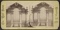 Historic organ inside Plymouth Church with wooden pipes and decorative elements