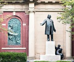 Statue of Henry Ward Beecher next to relief of Abraham Lincoln in Plymouth Church garden Brooklyn
